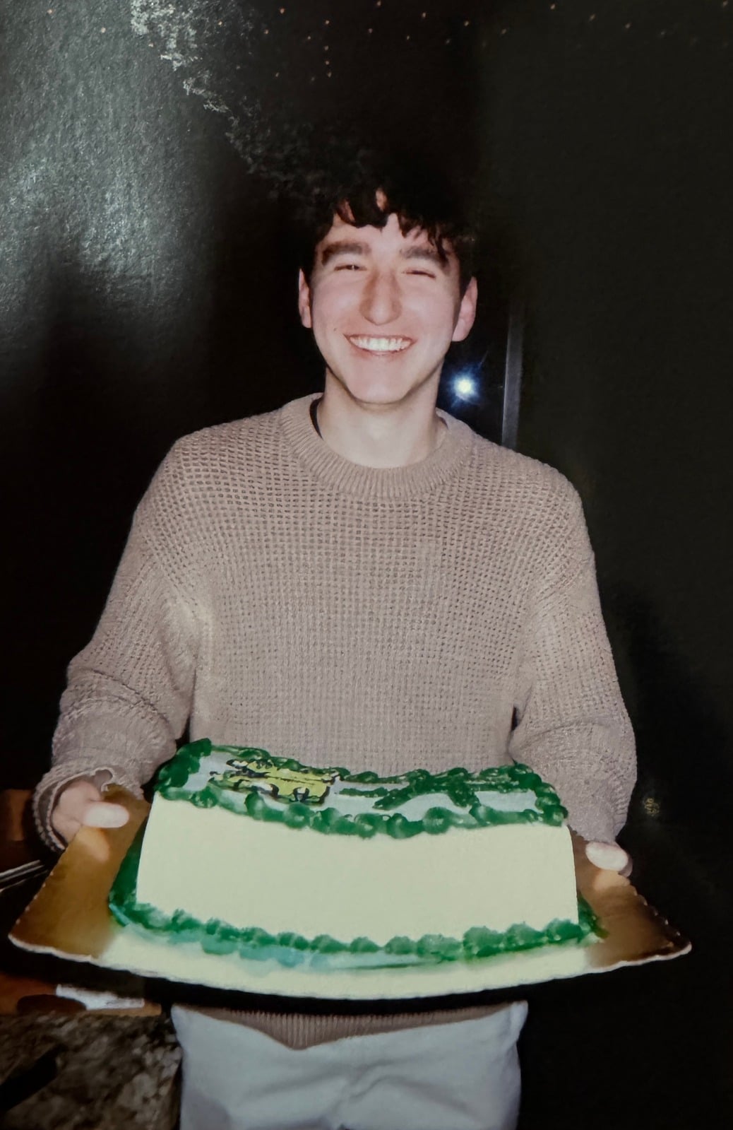 Team member holding the Arrowz cake
